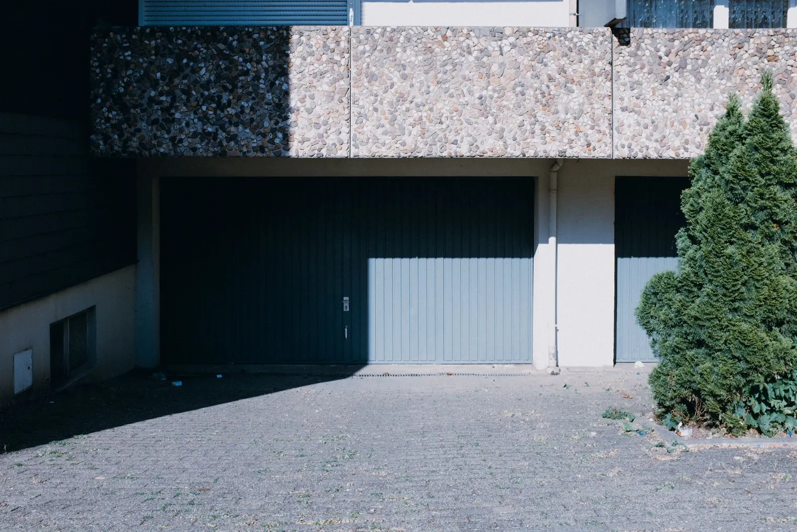 Residential facade with two garage doors